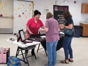 Sash Johnson of Choctaw Websites talking with visitors at a business fair in Atoka, OK